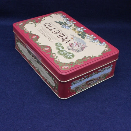 Decorative red tin box with floral design on a blue background