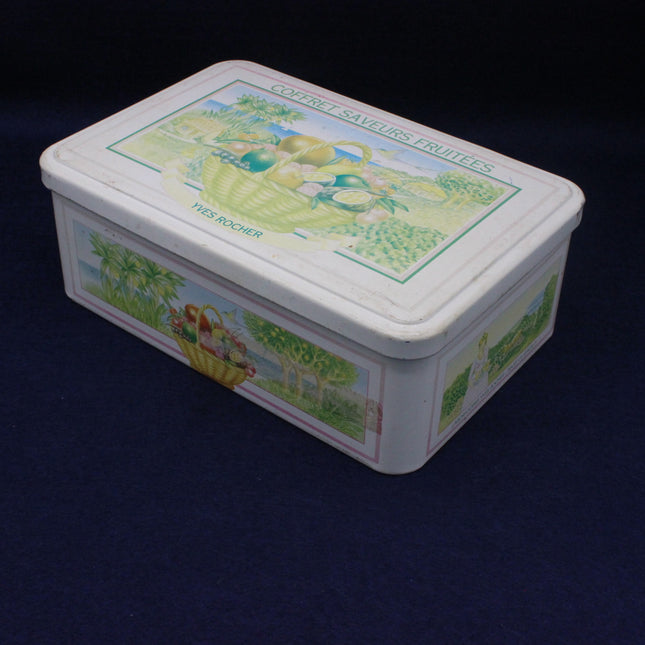 Rectangular tin box with decorative lid on a dark background
