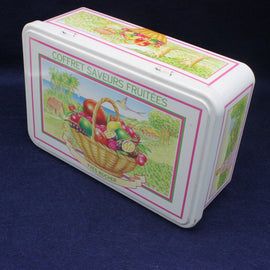 Decorative tin box with fruit-themed design on a dark blue background