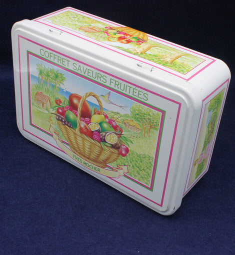 Decorative tin box with fruit-themed design on a dark blue background