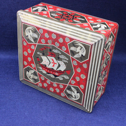 Red and black playing card deck with decorative design on a blue background