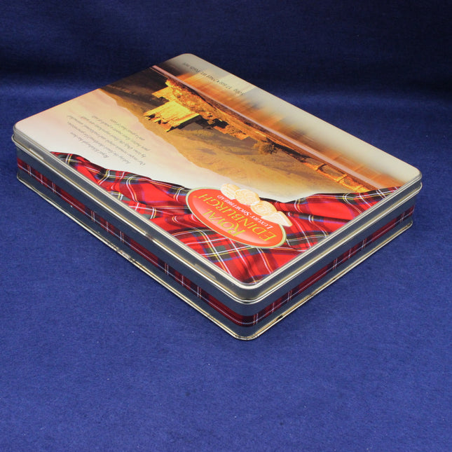 Tin box with a scenic design and visible brand logo on a blue background