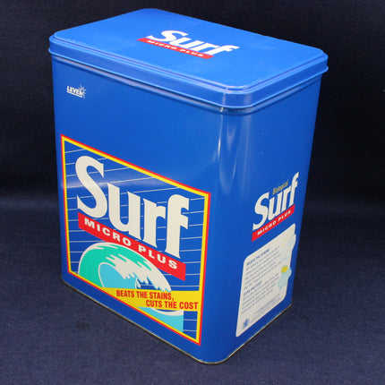 Blue vintage surf detergent container with branding on a dark background