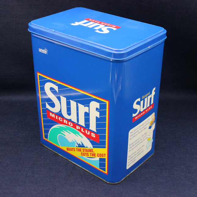 Blue vintage Surf Micro Plus cleaning product container on a dark background