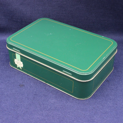 Green metal tin box with gold trim with Brooke Bonde Logo on a blue background