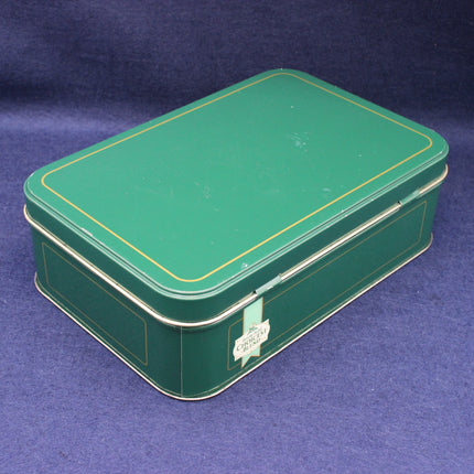 Green metal Brrooke Bond tea tin box with gold trim on a blue background