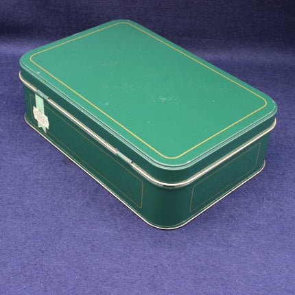 Green metal tin tea box on a blue background