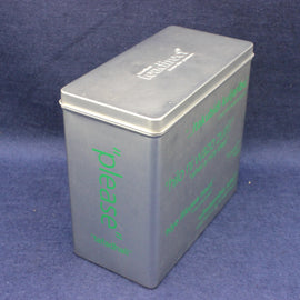 Metallic tea caddy tin with green text on a blue background