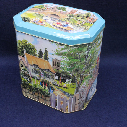 Decorative hexagonal tin with a colorful scene of a village on a blue background