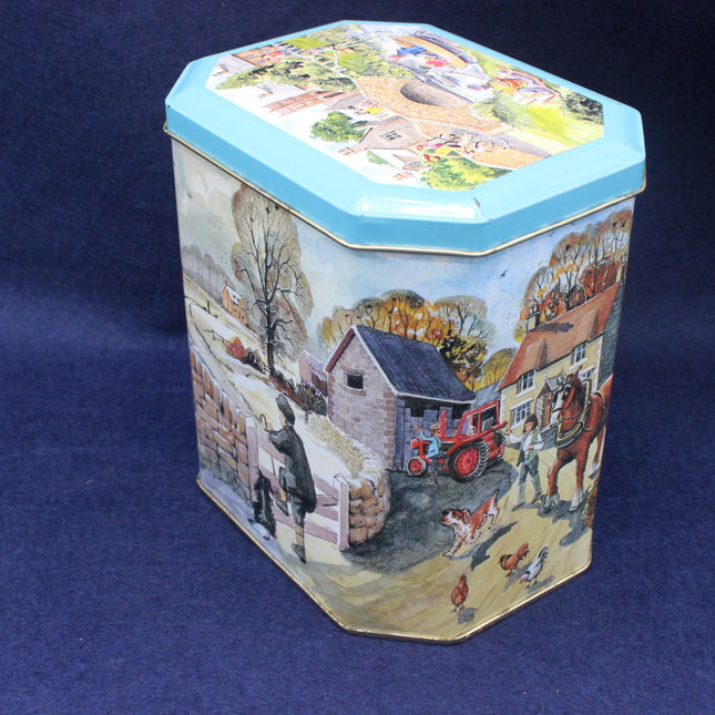 Hexagonal tin box with farm scene design on a blue background