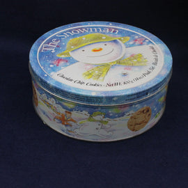 Cookie tin with snowman design on a dark background