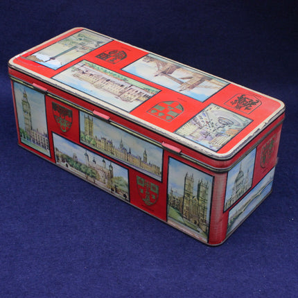 Rectangular tin box with decorative lid featuring illustrations on a blue background