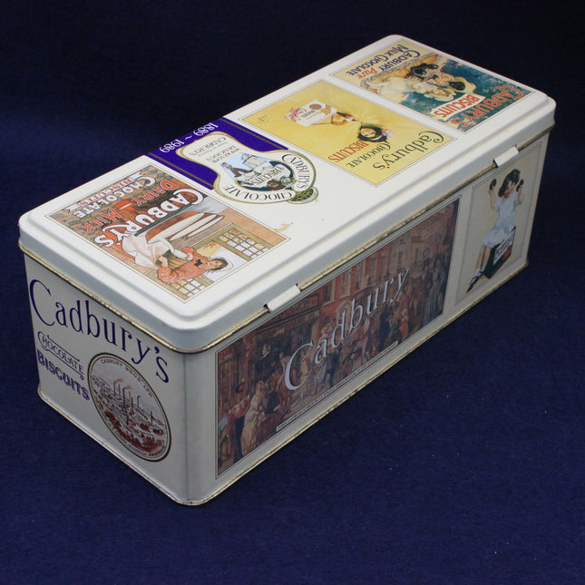 Cadbury's biscuit tin with vintage-style packaging on a dark blue background
