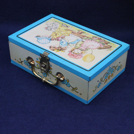 Decorative tin box with a colorful lid featuring cartoon characters on a blue background