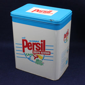 Vintage Persil laundry detergent container with blue lid on a dark background