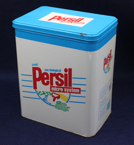 Vintage Persil laundry detergent container with blue lid on a dark background