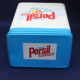 Blue and white container with Persil branding on a dark background
