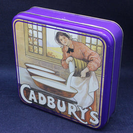 Cadbury's chocolate tin with vintage illustration on a dark blue background