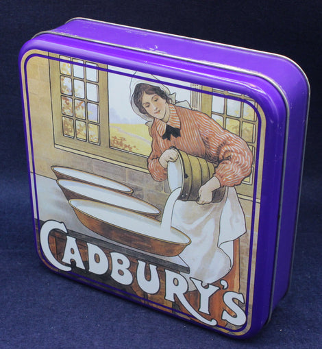 Cadbury's chocolate tin with vintage illustration on a dark blue background