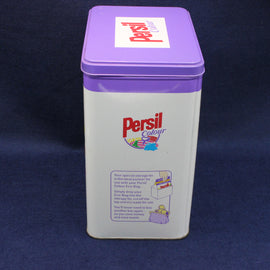 Persil laundry detergent tin with purple lid on a dark blue background