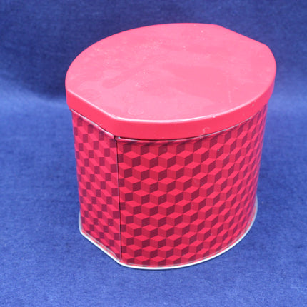 Red hexagonal tin container with a pattern on a blue background