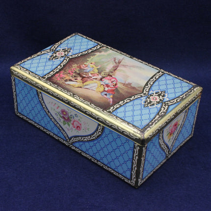 Decorative biscuit box with painted lid on a blue background