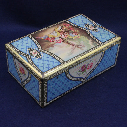 Decorative chest style biscuit tin with floral design on a blue background