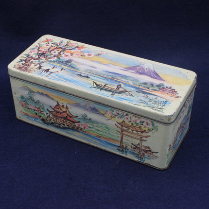 Decorative tin box with scenic artwork on a blue background