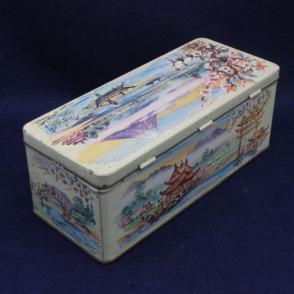 Decorative tin box with colorful artwork on a dark blue background