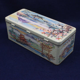Decorative tin box with artistic design on a blue background