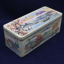 Decorative vintage tin box with lake design on a blue background