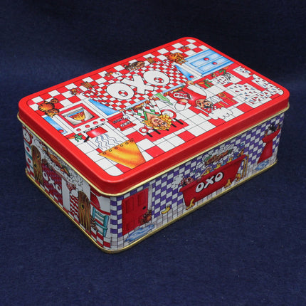 Decorative OXO tin box with colorful design on a dark blue background