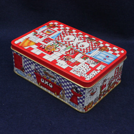 Decorative rectangular tin box with colorful design on a dark blue background