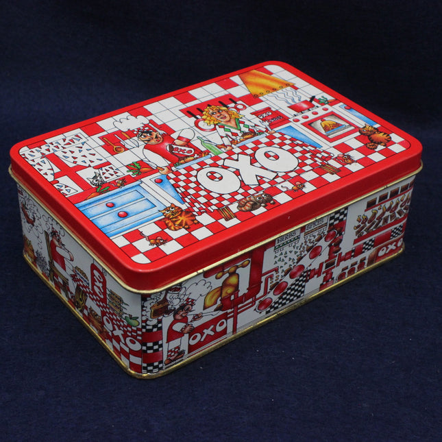 Decorative rectangular tin box with colorful graphics on a dark background
