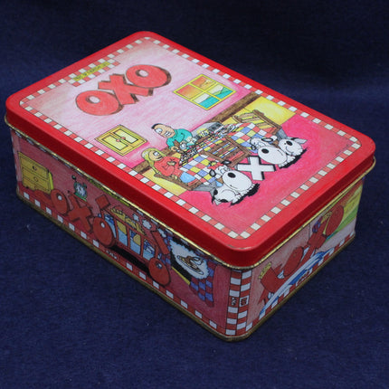 Colorful rectangular tin box with cartoon design on a dark background