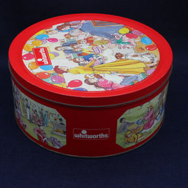 Round red tin with colorful illustrations and 'Whitworths' branding on a dark background