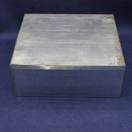 Metal box with 'St Michael' branding on a blue background