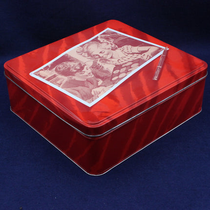 Red metal tin with vintage-style illustration on a dark blue background