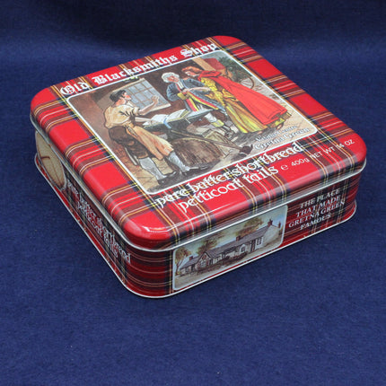 Vintage-style tin box with plaid design and historical illustration on a blue background