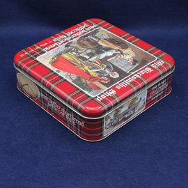 Vintage-style tin box with plaid design and illustrations on a blue background
