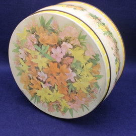 Round tin with floral design on a blue background