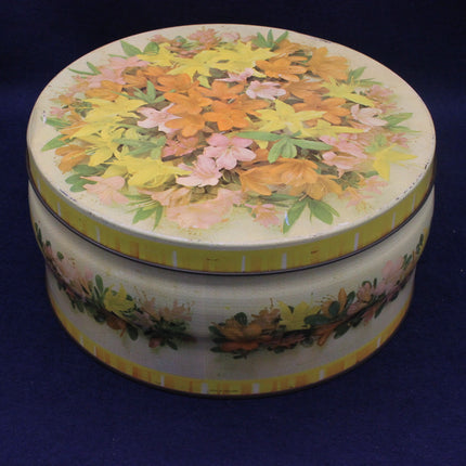 Round decorative tin with floral design on a blue background