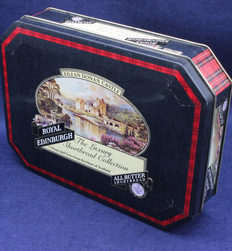 picture of Eilean Donan Castle on a black tin