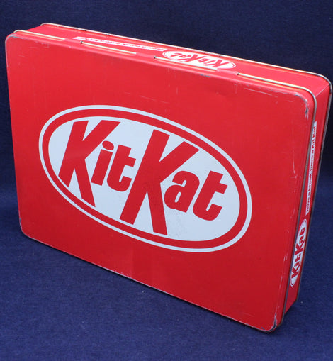 Red KitKat tin box on a blue background
