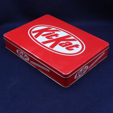 Red Kit Kat chocolate bar box on a dark blue background
