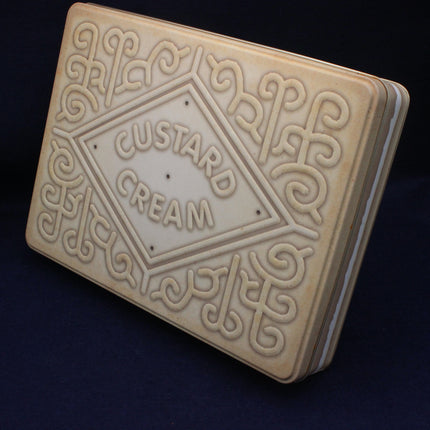 Cookies with 'custard cream' branding on a dark background