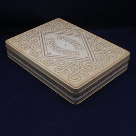 Tin biscuit  box with intricate impressions on a dark background