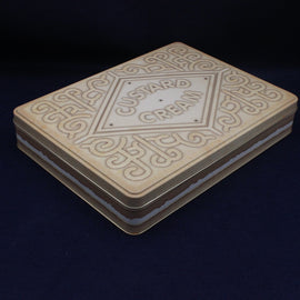Stack of cookies with 'Custard Cream' branding on a dark background
