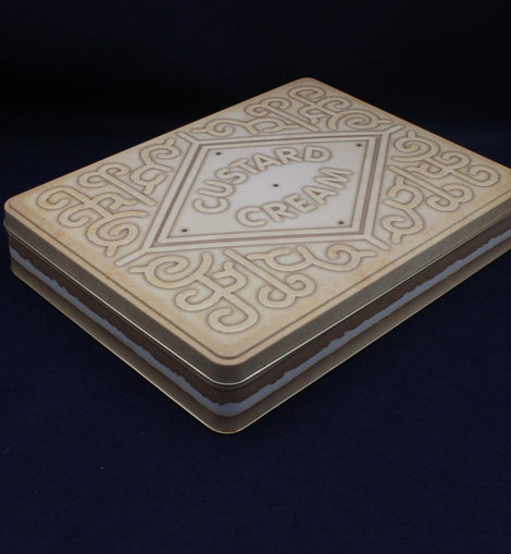 Stack of cookies with 'Custard Cream' branding on a dark background