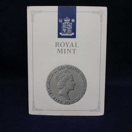 Royal Mint packaging with a profile of a queen and their logo on a dark background
